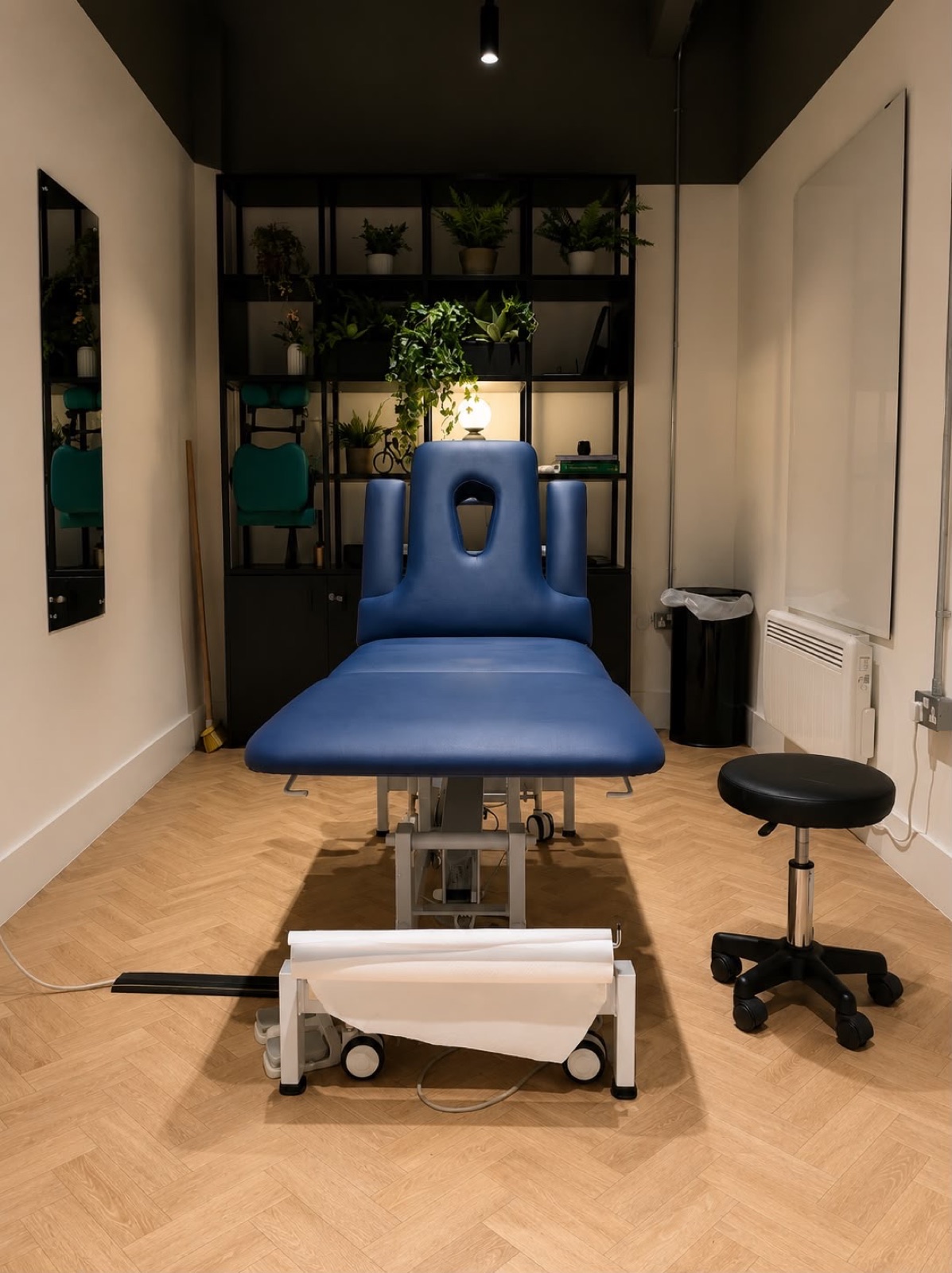 Treatment room with a height-adjustable plinth at Full Motion Physio Manchester