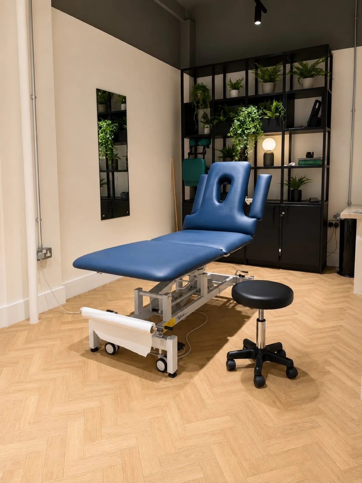 Treatment room with a height-adjustable plinth at Full Motion Physio Manchester