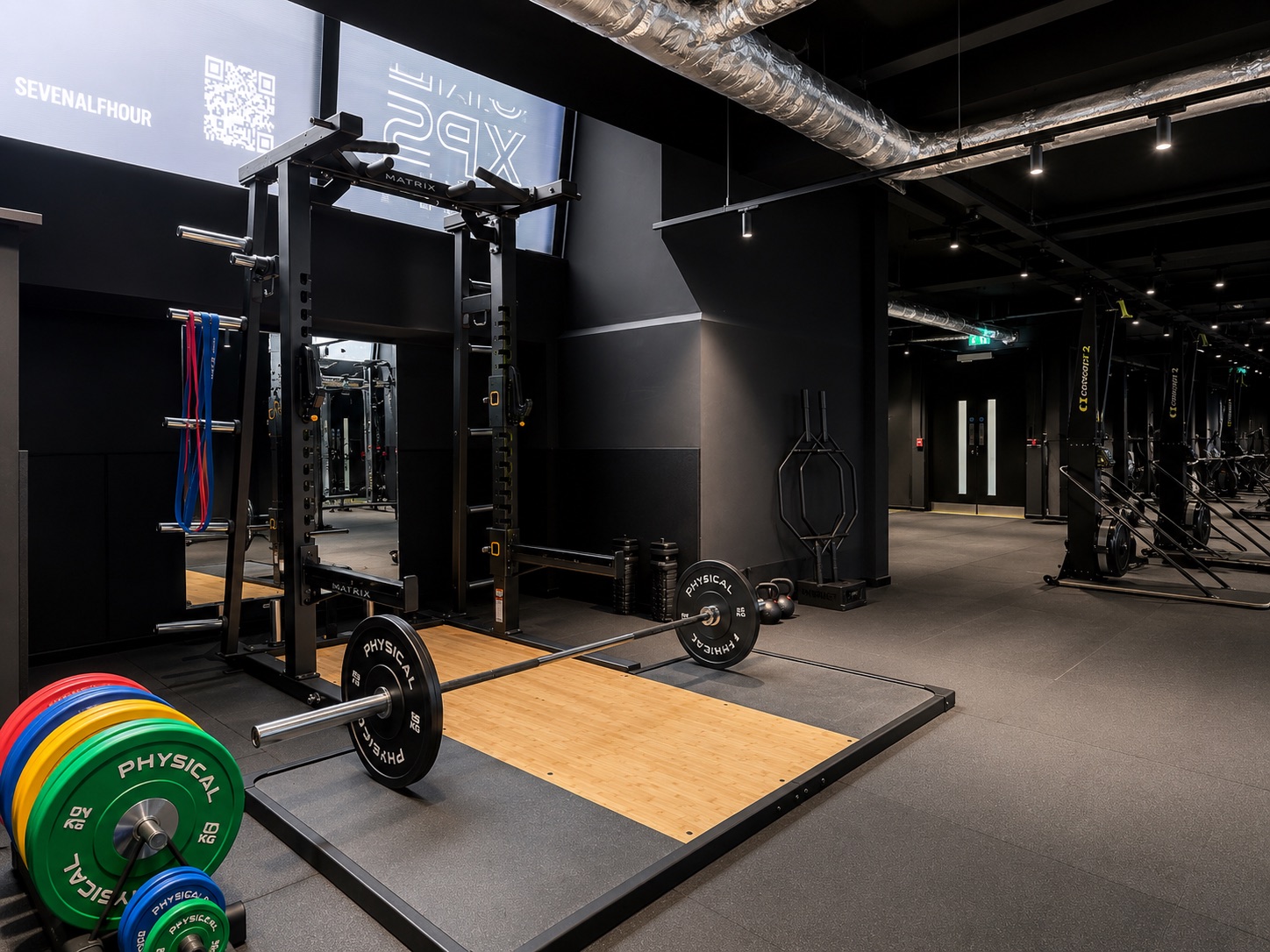 Squat rack and Olympic lifting platform at the gym used by Full Motion Physio Manchester