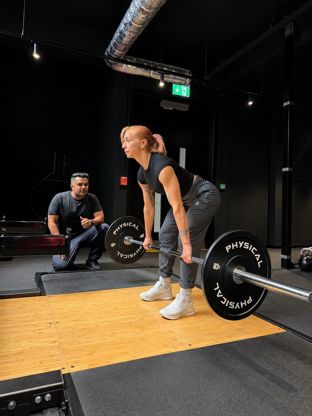 Khuram coaching an athlete through a strength exercise in the performance gym at Full Motion Physio Manchester