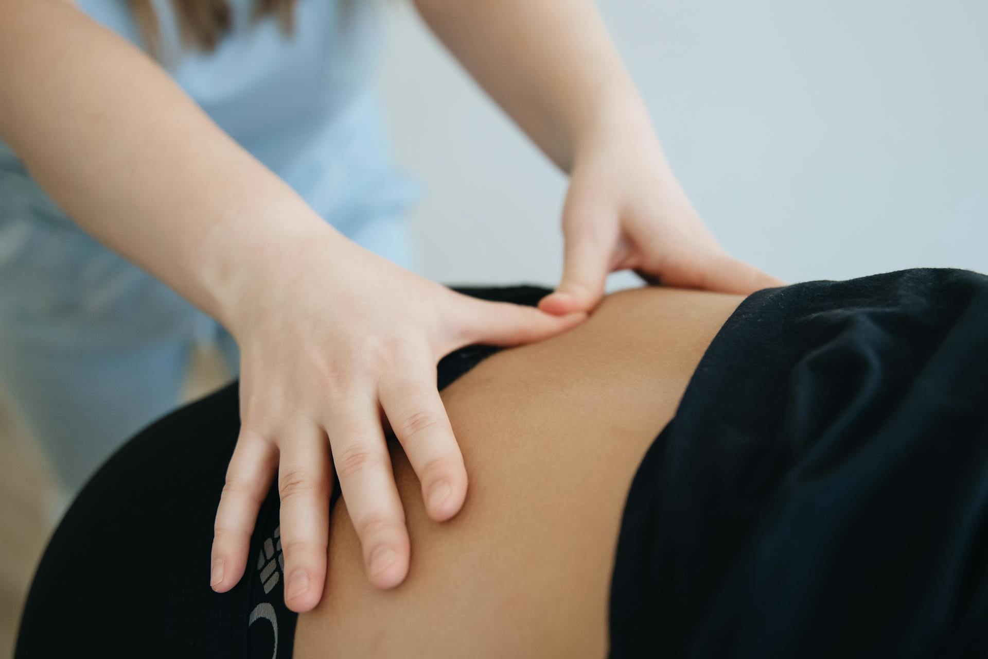 Physiotherapist providing hands-on manual therapy to a patient's lower back