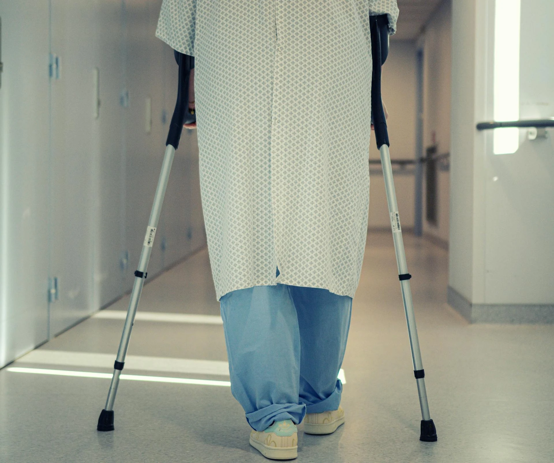 Patient walking with crutches during post-surgical rehabilitation