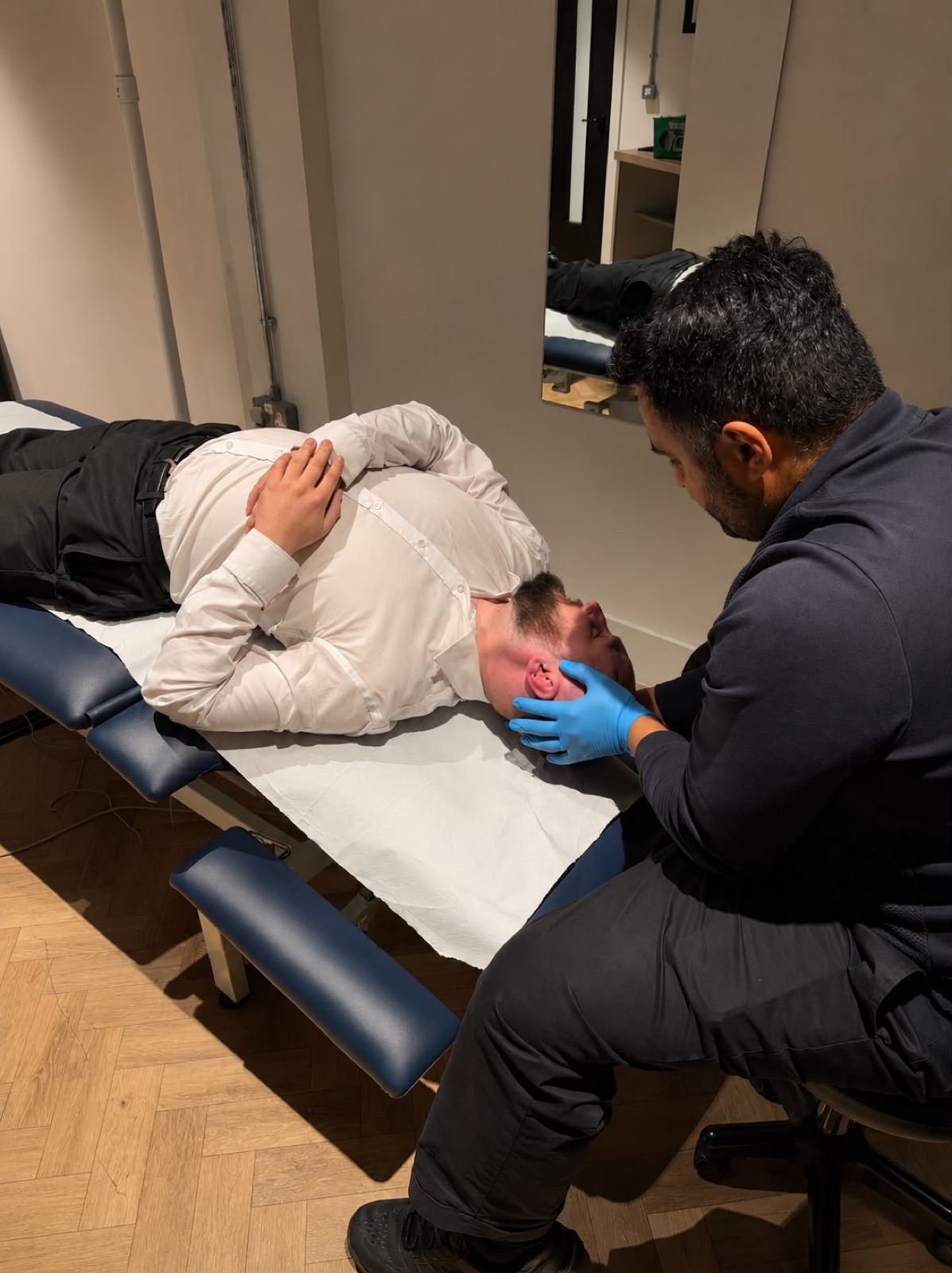 Physiotherapist performing a positional repositioning manoeuvre for BPPV at Full Motion Physio Manchester